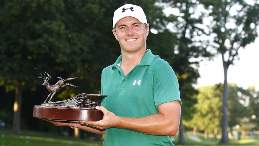 Jordan Spieth holds the trophy afer winning the PGA Tour event at Silvis, Illinois.
