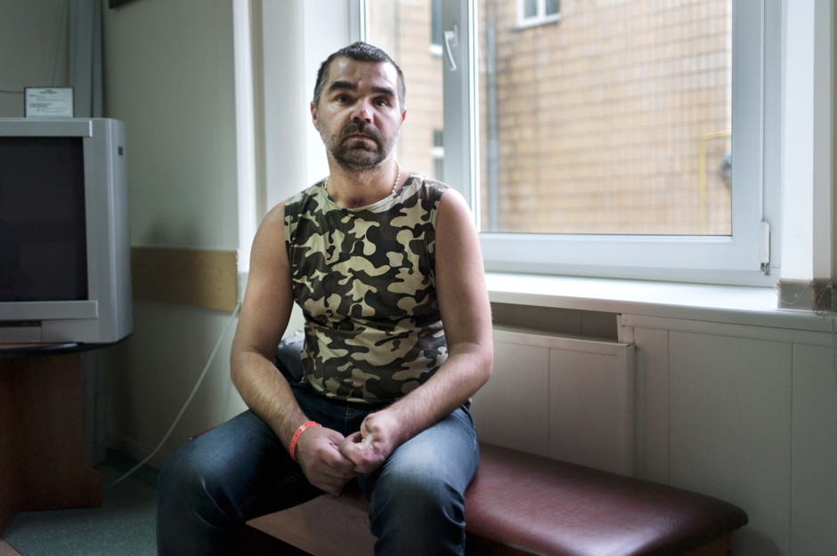 Carpenter-turned-soldier Sergey sits in the waiting room of the hospital, after a 300-kilometre drive for surgery.