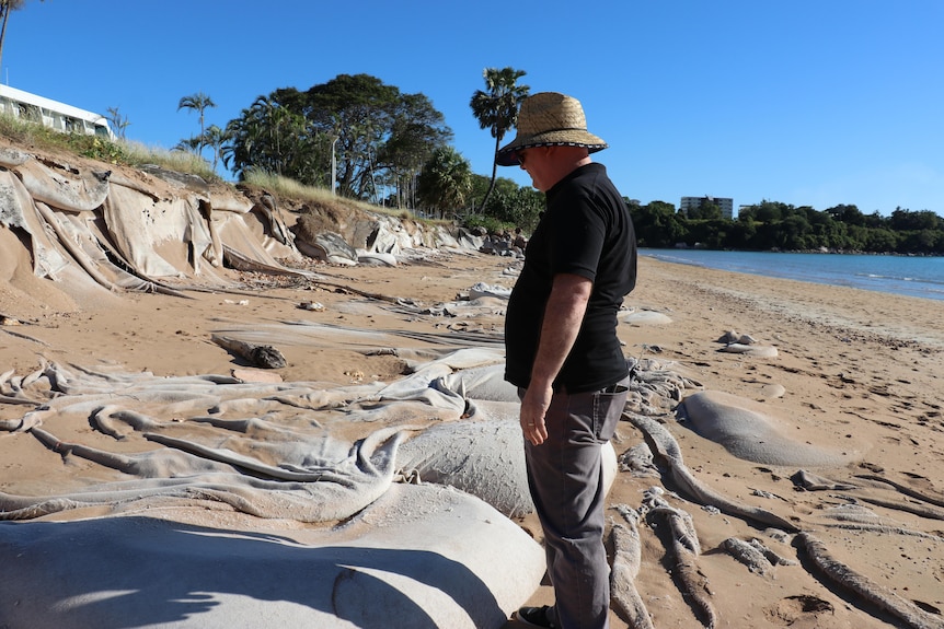 Michael Buring looks across the wall of sandbags at Mindil Beach.