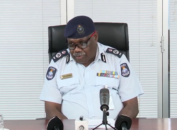 A man in police uniform answers questions from the media in Fiji