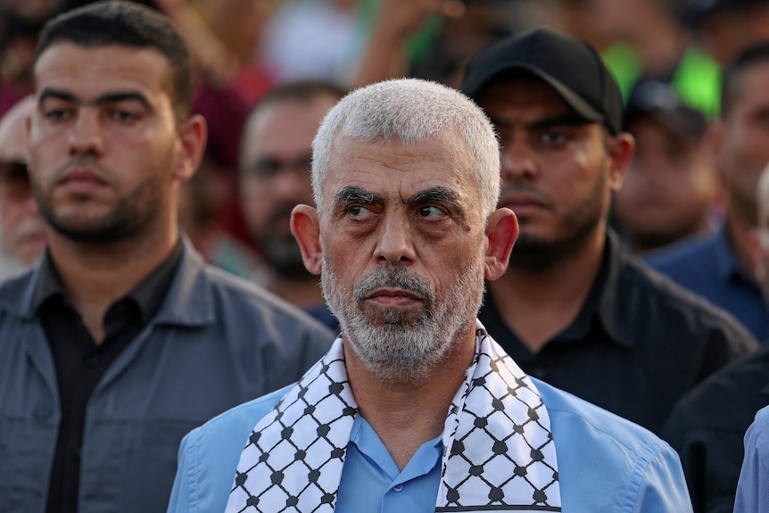 A close up of Yahya Sinwa at a rally among a crowd of people.