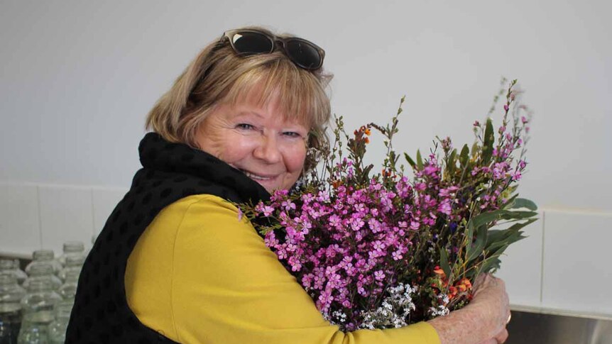 Ravensthorpe Wildflower Show coordinator Sue Leighton with a bucket full of wildflowers.