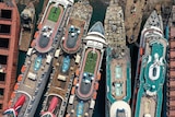 five cruise ships docked together can be seen from above