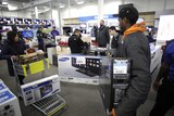 Customers taking Samsung TVs from a store.