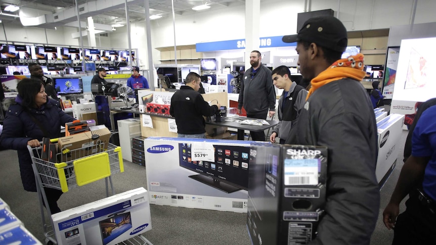 Customers taking Samsung TVs from a store.