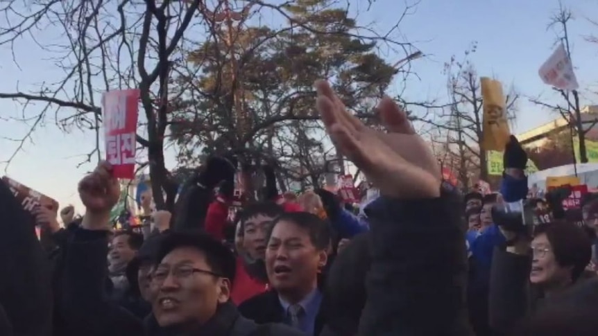 Crowds celebrate outside South Korea's National Assembly after the impeachment verdict