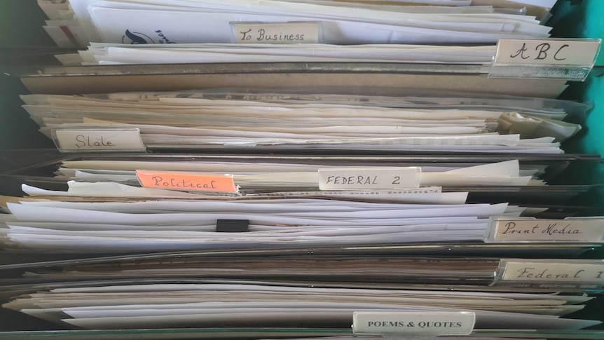 Old style filing drawer full of documents, shown from above, with tags such as 'To business', 'ABC'