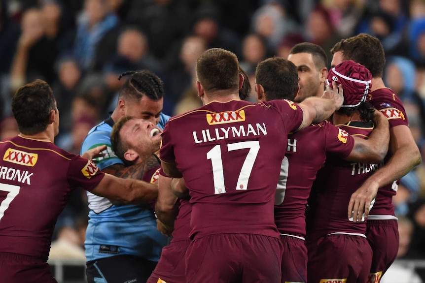 Andrew Fifita of the Blues grabs Gavin Cooper