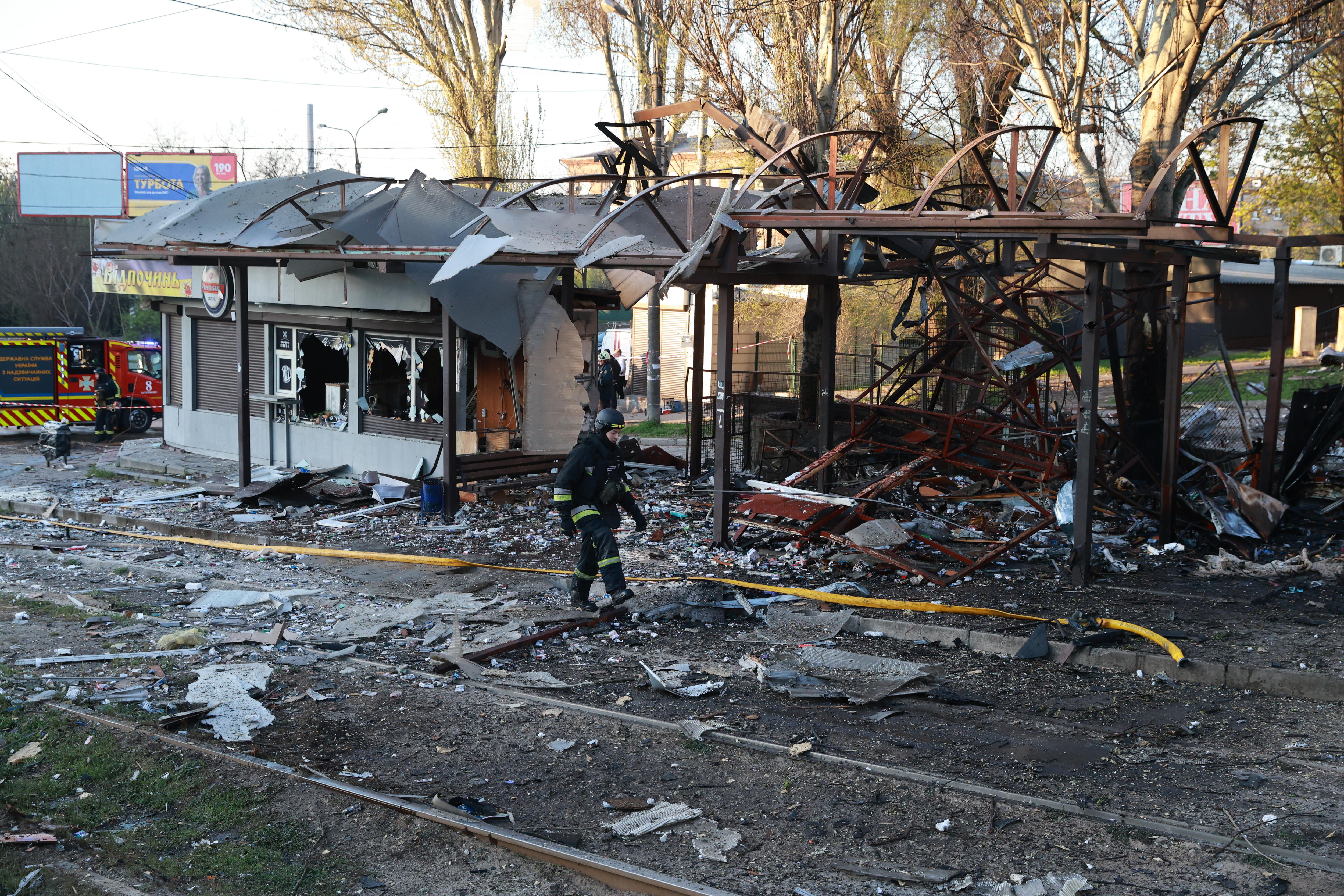 A destroyed bus shelter in a park.