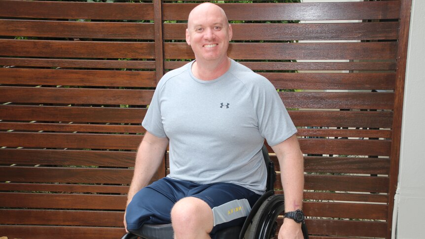 Byron Smith in his wheelchair in a courtyard