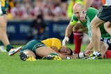 Wallabies player Christian Lealiifano lies motionless on the ground