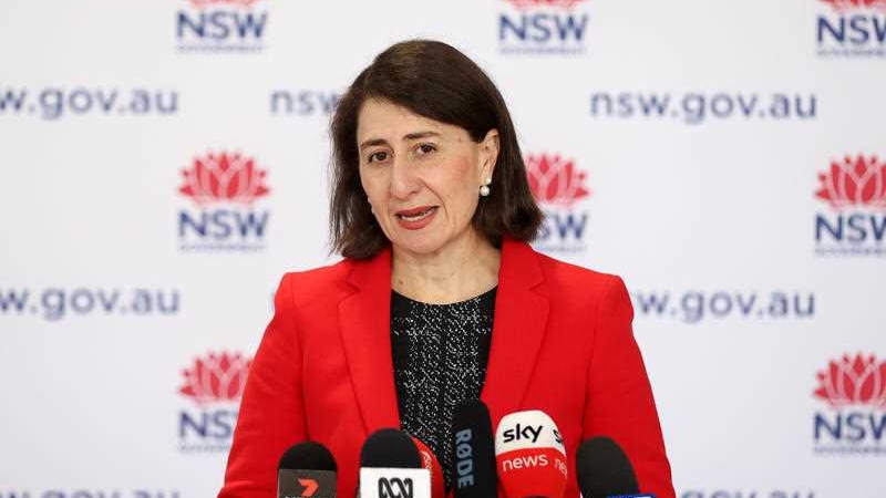 NSW Premier Gladys Berejiklian speaks to the media in a red jacket