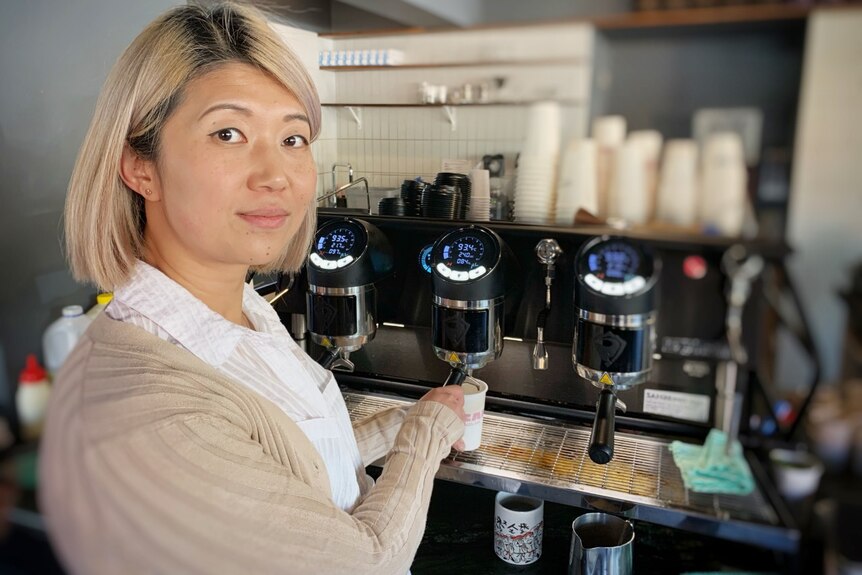 Hobart cafe owner Alicia Liu operates a coffee machine