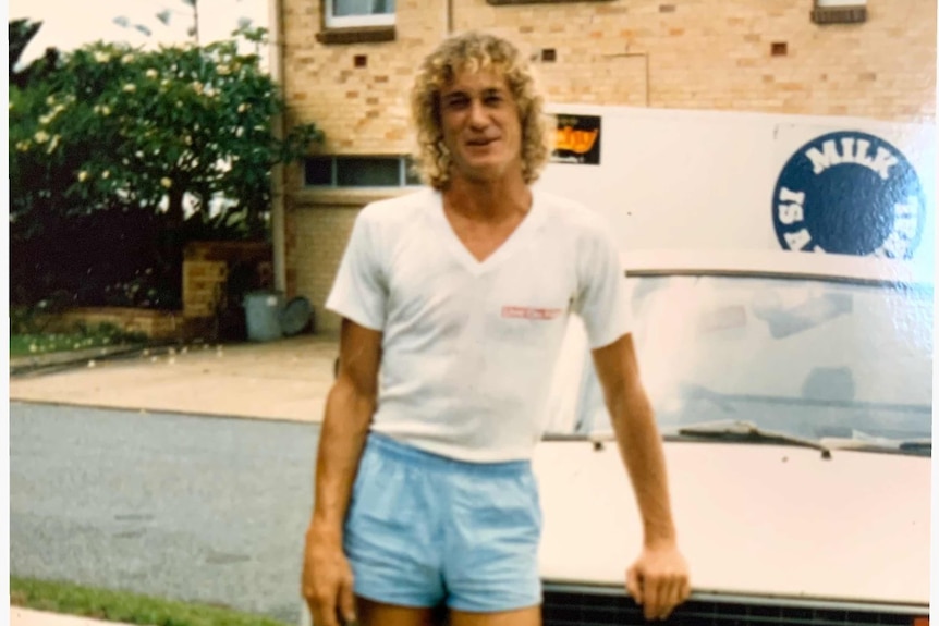 Trevor Foster stands in front of a car.