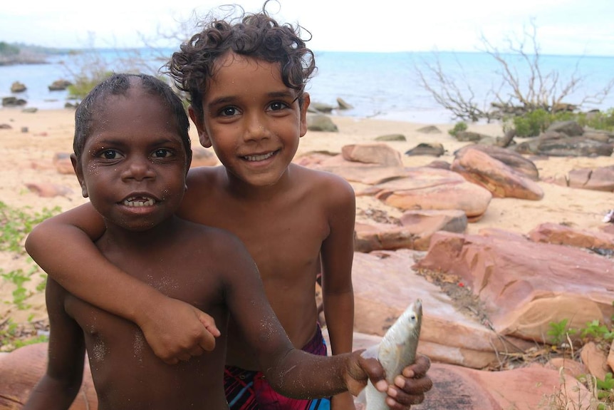 Children with a fish they caught at Elcho Island homeland