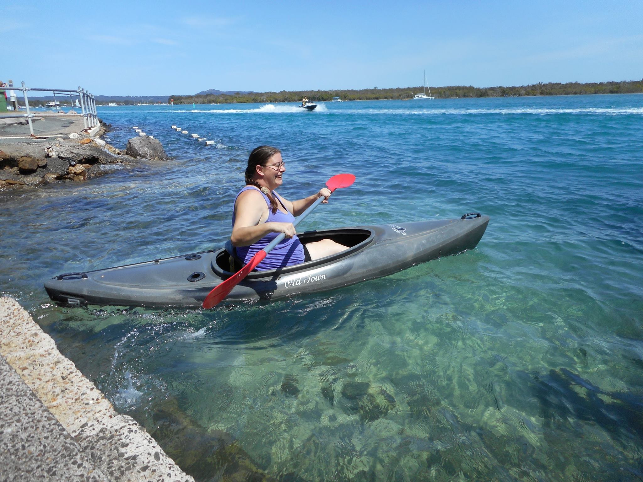 A woman in a canoe paddling on the water.