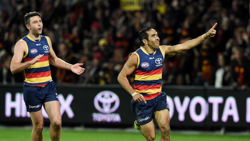 Two Crows players celebrate after scoring.