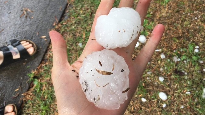 A person holding hailstones