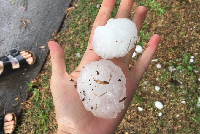 A person holding hailstones