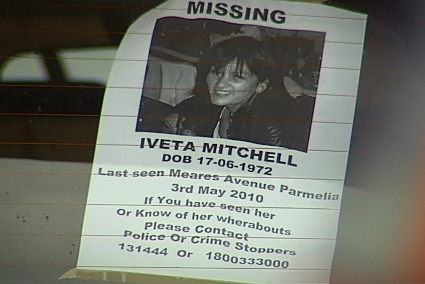 A missing person's poster on a rear car window 