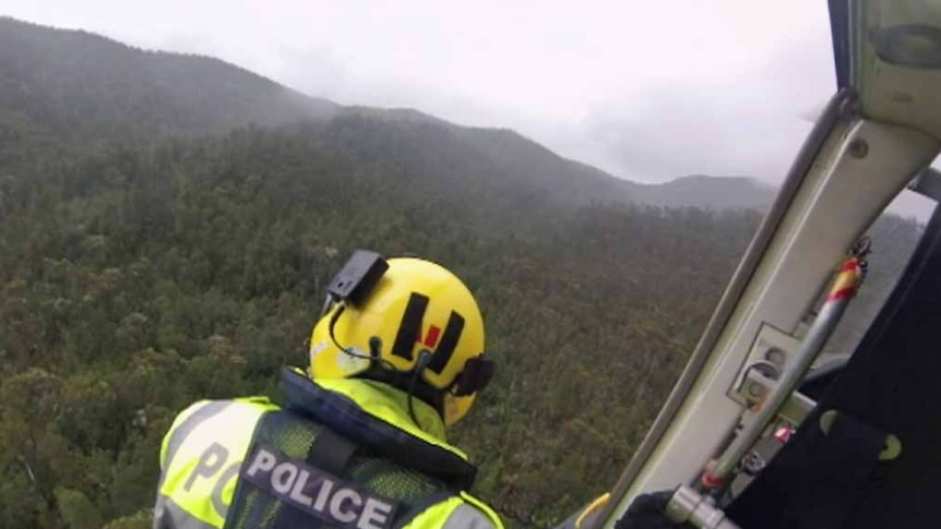 Tasmania Police in the rescue helicopter searching for bushwalkers in the World Heritage Wilderness Area
