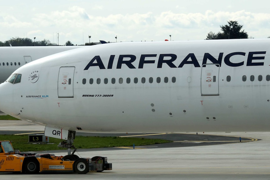 An Air France Boeing 777-300ER on the tarmac at an airport.