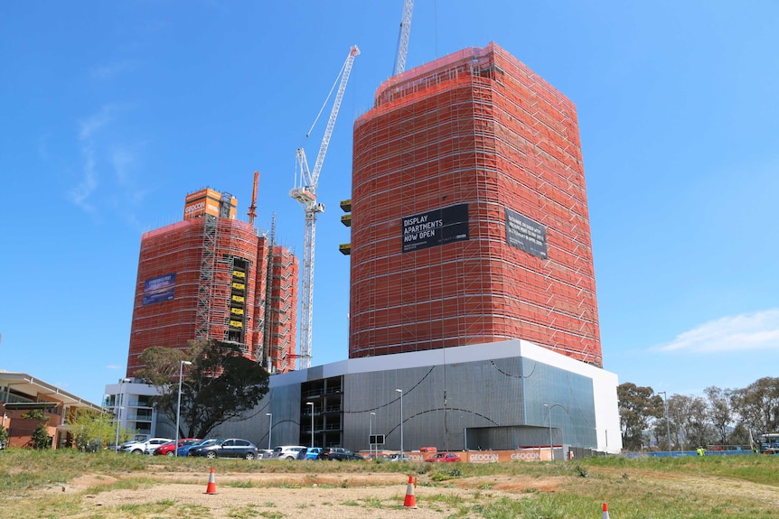 Two large high-rise buildings under construction.