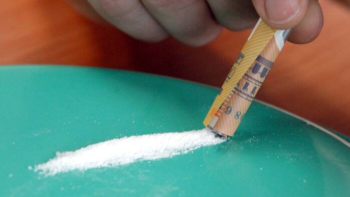 A cocaine user snorts cocaine