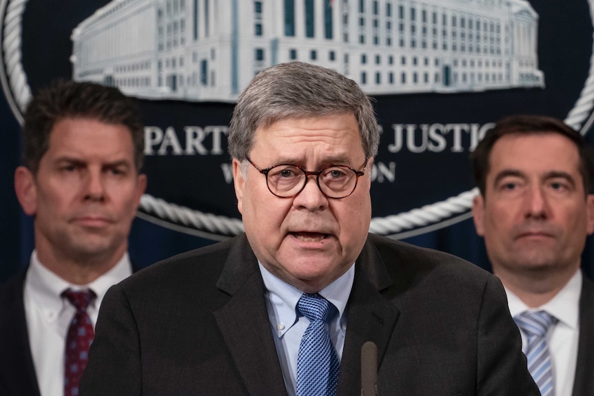 US Attorney General William Barr, joined by FBI Deputy Director David Bowdich, left, and other officials, speaks to reporters.