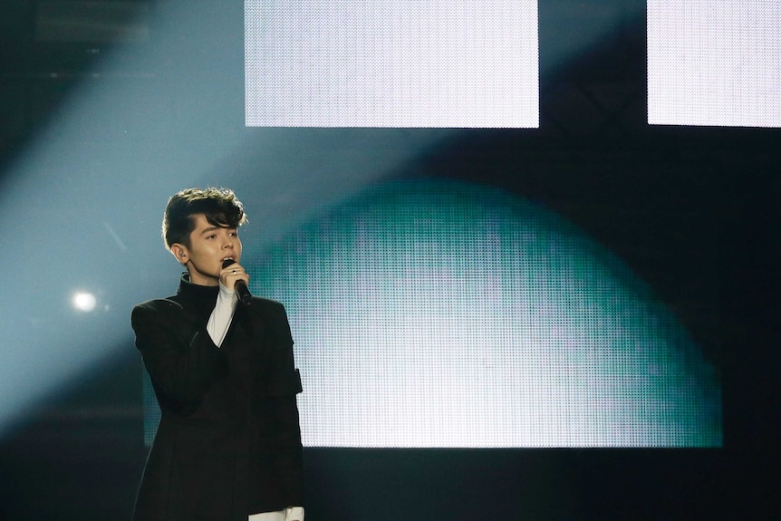 Kristian Kostov from Bulgaria performs his song Beautiful Mess during the Grand Final wearing black and white