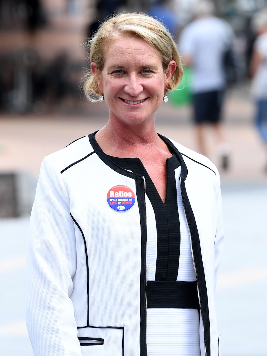 Woman in white smiling 