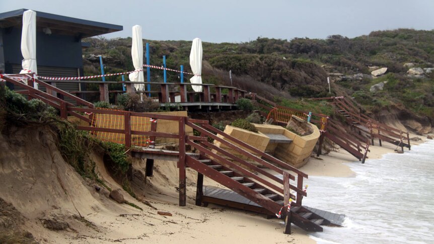 A cafe at Gnarabup lies in ruins after being battered by gale force winds and huge swells.
