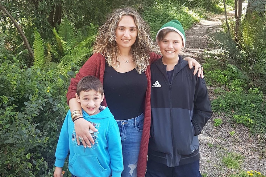Stephanie Yiallourou stand on a walking trail with her children.