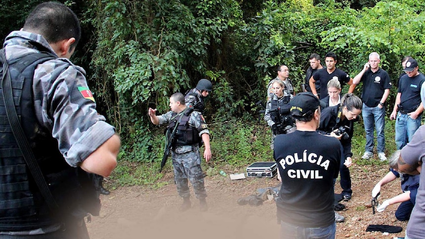 Brazilian police surround the corpses of three criminals