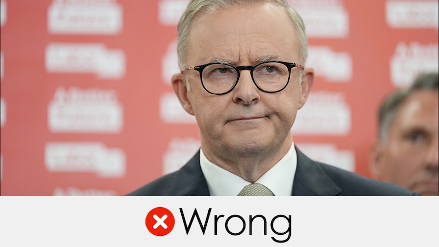 Opposition Leader Anthony Albanese wears black glasses in front of a red background. Verdict: WRONG with a red cross