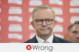 Opposition Leader Anthony Albanese wears black glasses in front of a red background. Verdict: WRONG with a red cross