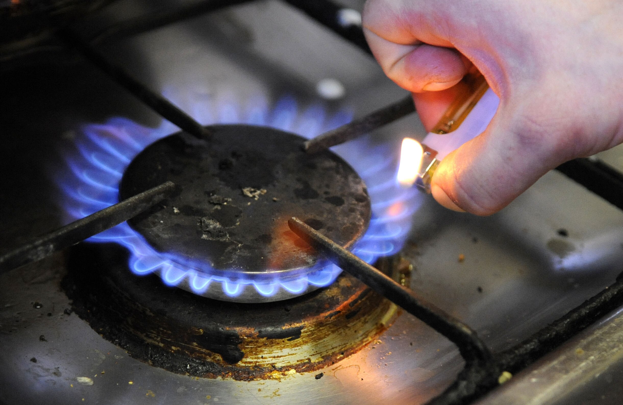 Hand lights a gas stove