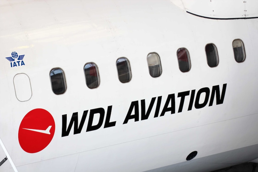 The side of a plane with the logo for WDL Aviation featured below the windows.