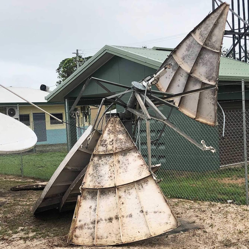 A metal satellite dish torn to pieces