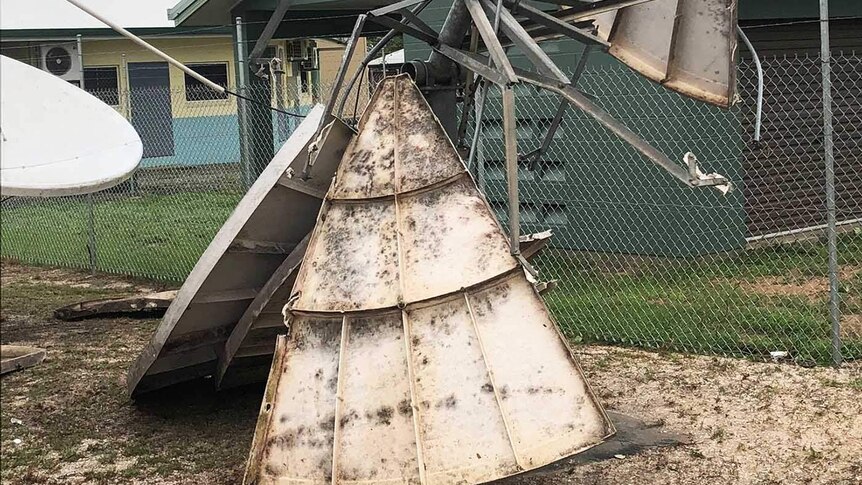 A metal satellite dish torn to pieces