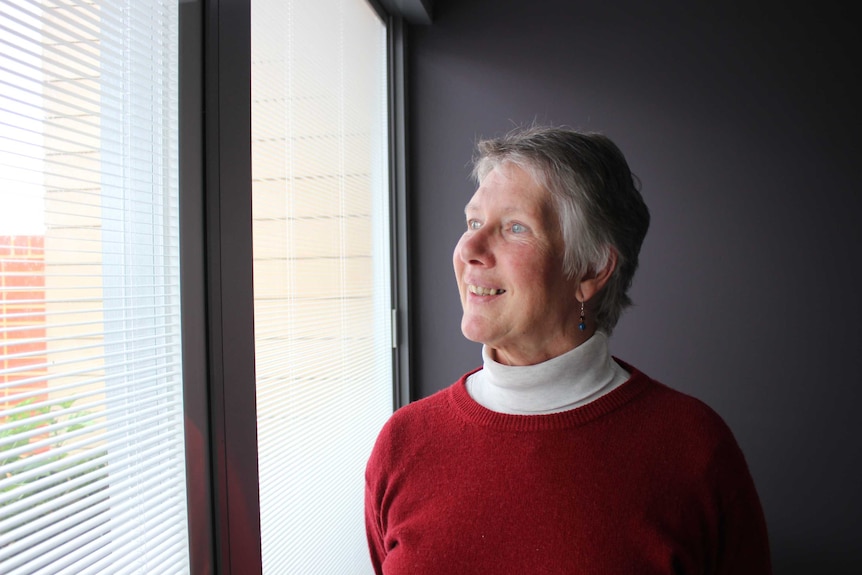 Albany Death Cafe organiser Irene Montefiore looks out a window.