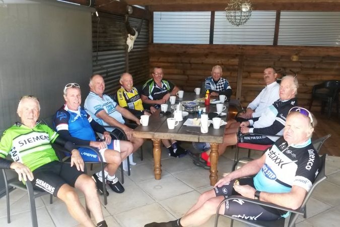 cyclists' enjoying a coffee around a table 