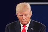 Donald Trump listens with his eyes shut