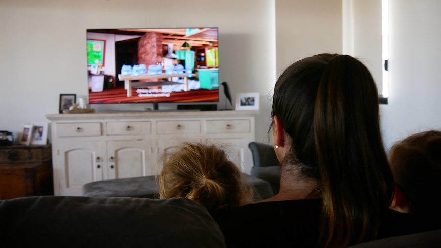 A family watching television in Broome, May 2022. 