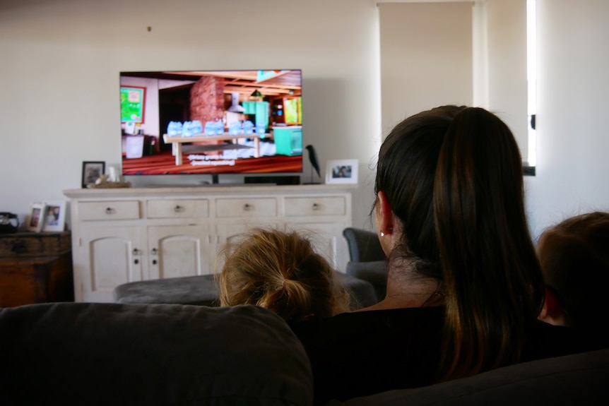 A family watching television in Broome, May 2022. 