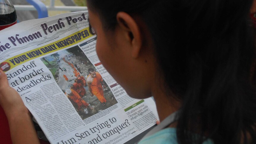 A person reads the Phnom Penh Post