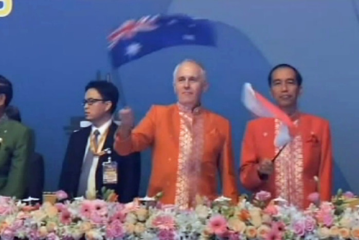 Prime Minister Malcolm Turnbull waving an Australian flag during ASEAN celebrations in Kuala Lumpur on November 22, 2015.
