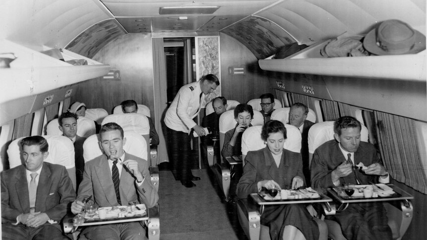 Passengers enjoying a meal on the Lockheed Super Constellation in the 1950s