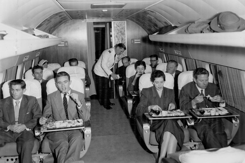 Passengers enjoying a meal on the Lockheed Super Constellation in the 1950s