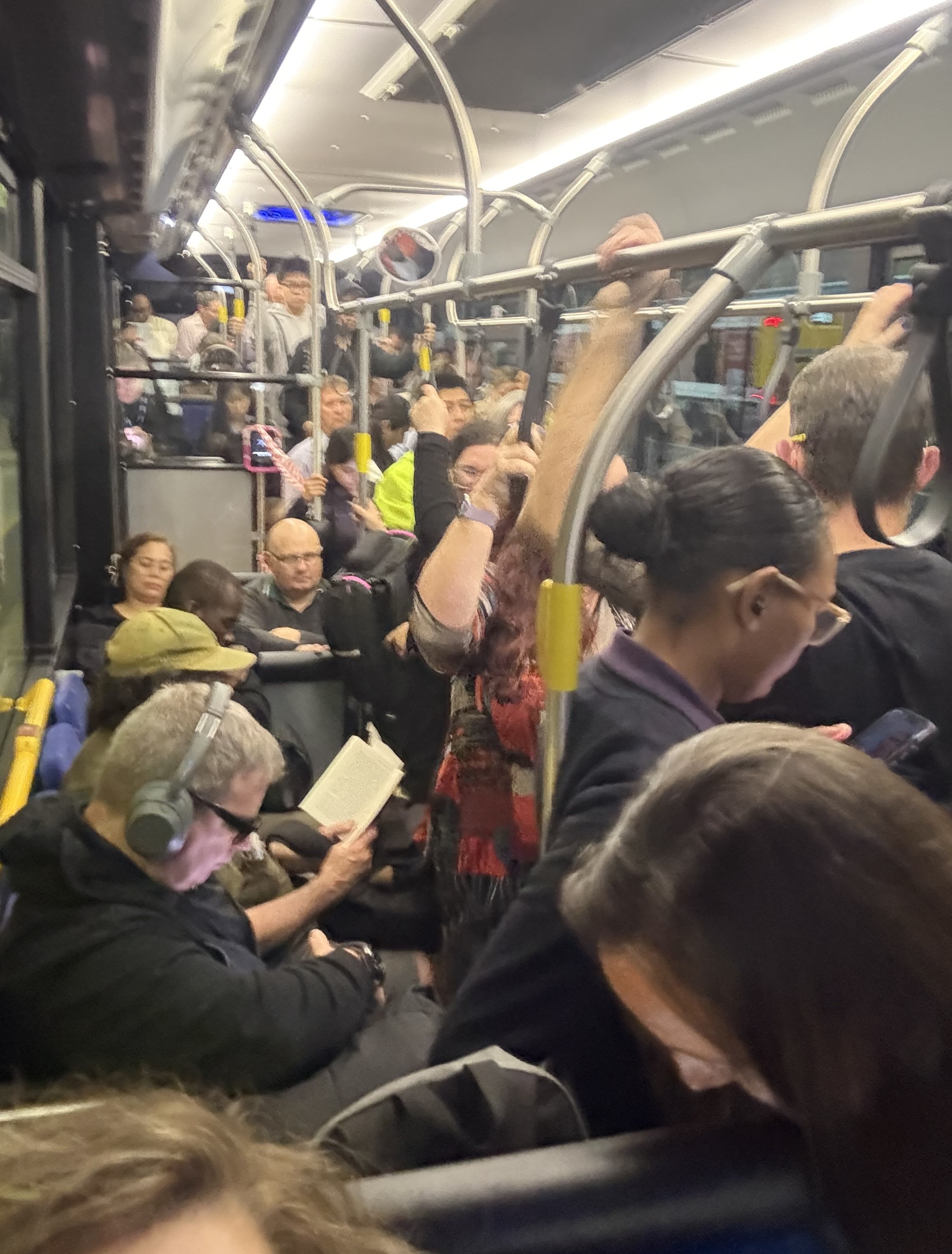 Inside a bus packed with people. 